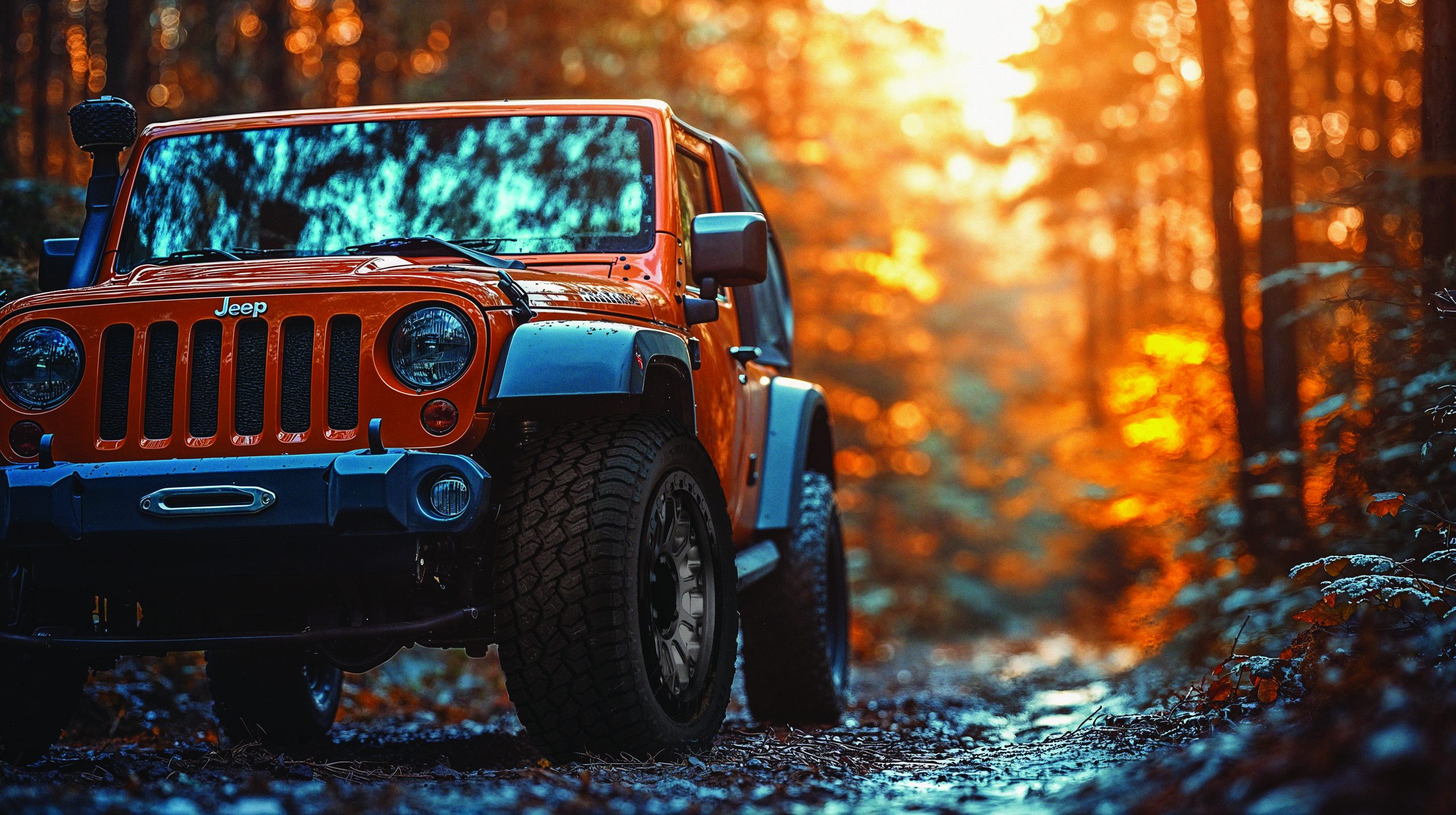 Orange off-road SUV with all-terrain tires on a forest trail at sunset